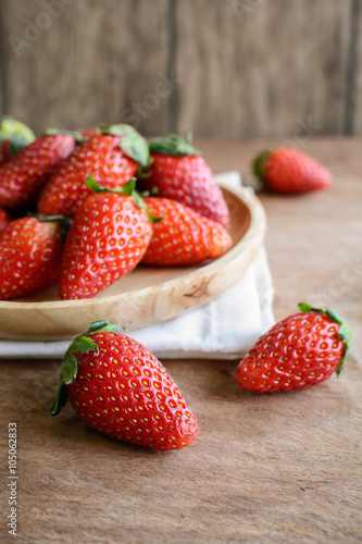 Fresh strawberries on rustic wooden table