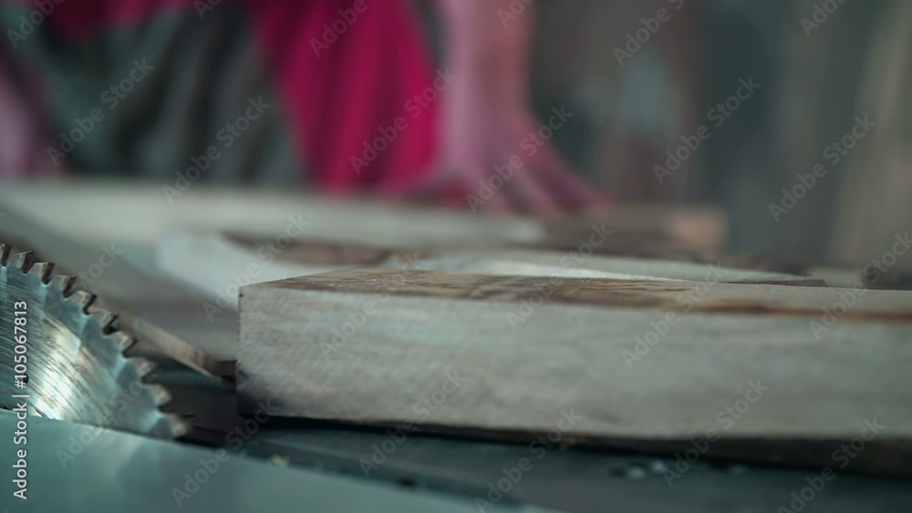 Wooden plank next to the saw blade Wooden plank next to the saw blade