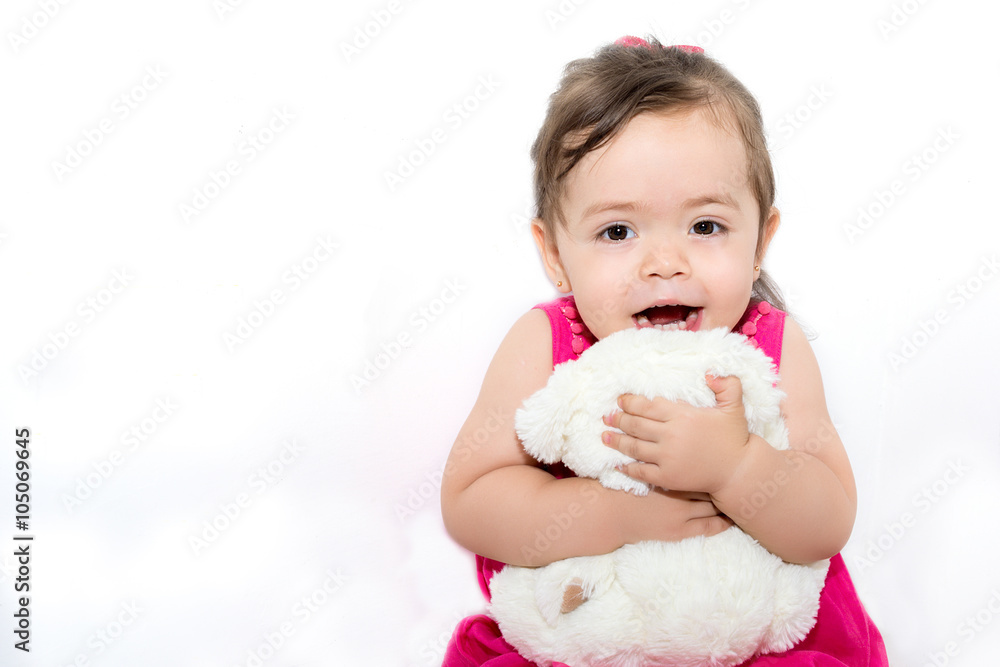 Adorable little girl hugging a teddy bear Adorable little girl hugging a teddy bear