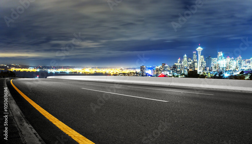 asphalt road with cityscape of seattle at night