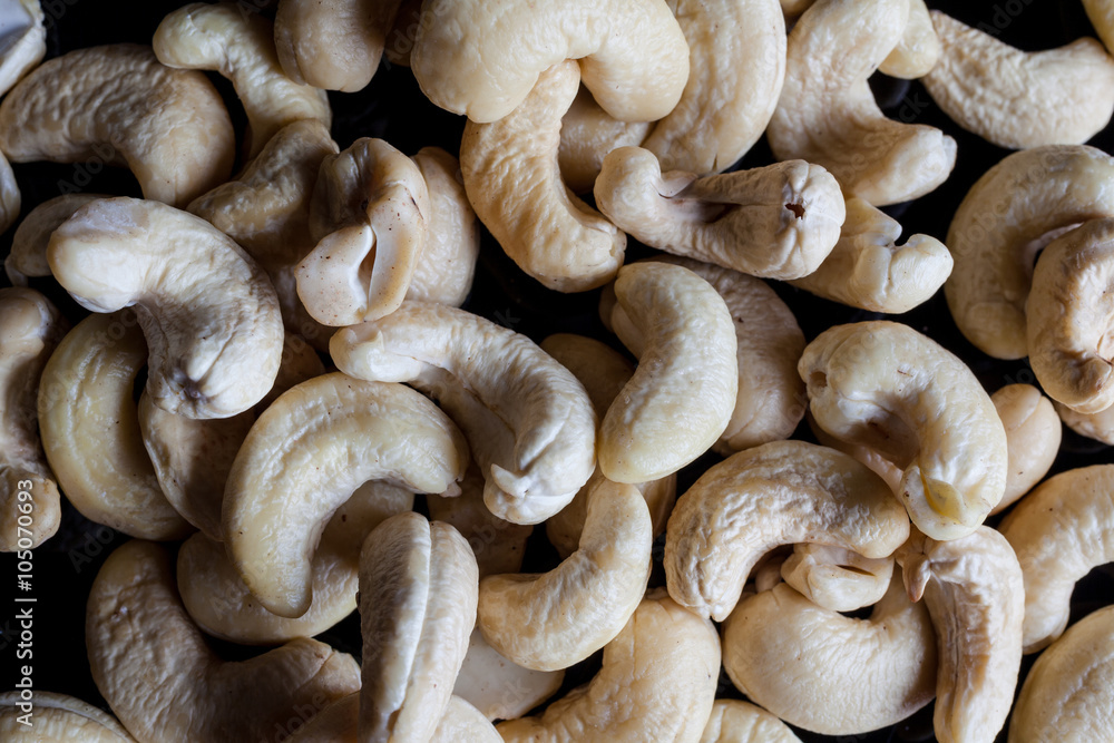 Cashew nuts on black background directly from above closeup Cashew nuts on black background directly from above closeup