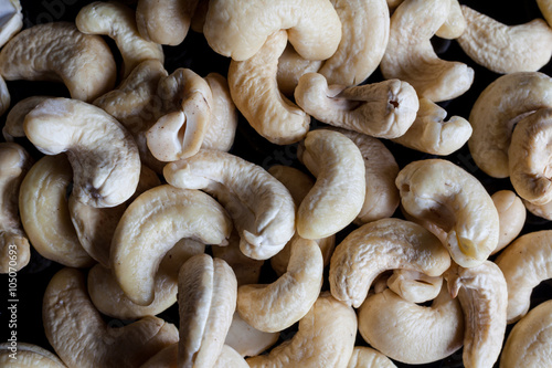 Cashew nuts on black background directly from above closeup