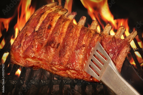 BBQ Roasted Baby Back Pork Ribs On Hot Flaming Grill photo