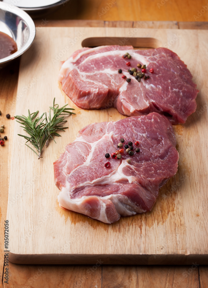 pork with pepper and rosemary for grill on chopping block pork with pepper and rosemary for grill on chopping block