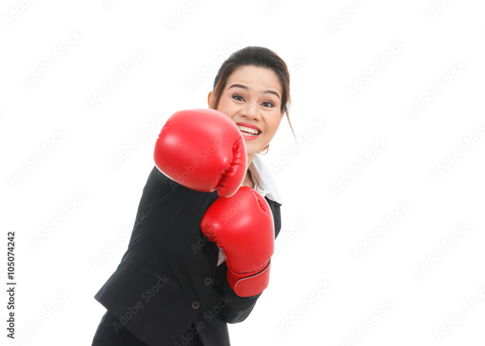 Asian business woman with boxing gloves punching isolated on whi Asian business woman with boxing gloves punching isolated on whi