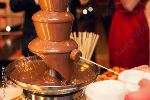 the chocolate fountain on a holiday table photo