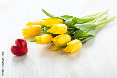 Beautiful bouquet of yellow tulips on white table
