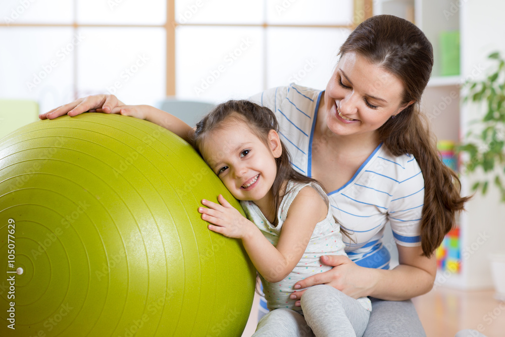 Cute kid girl and mother with fitness ball Cute kid girl and mother with fitness ball