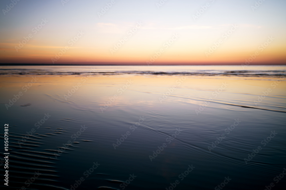 calm sunset over baltic sea beach, shallow focus