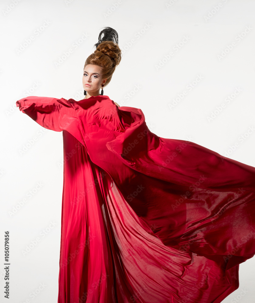 Beautiful woman in a silk red fabric on the white background