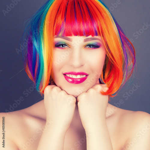 beautiful woman wearing colorful wig and showing colorful nails