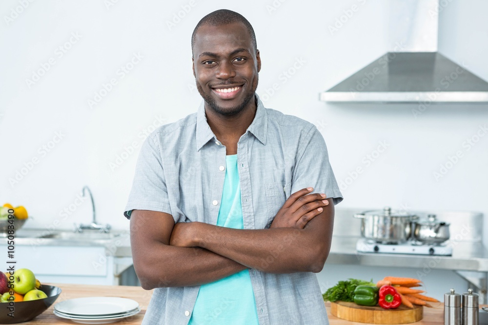 Man standing with arms crossed in kitchen Man standing with arms crossed in kitchen