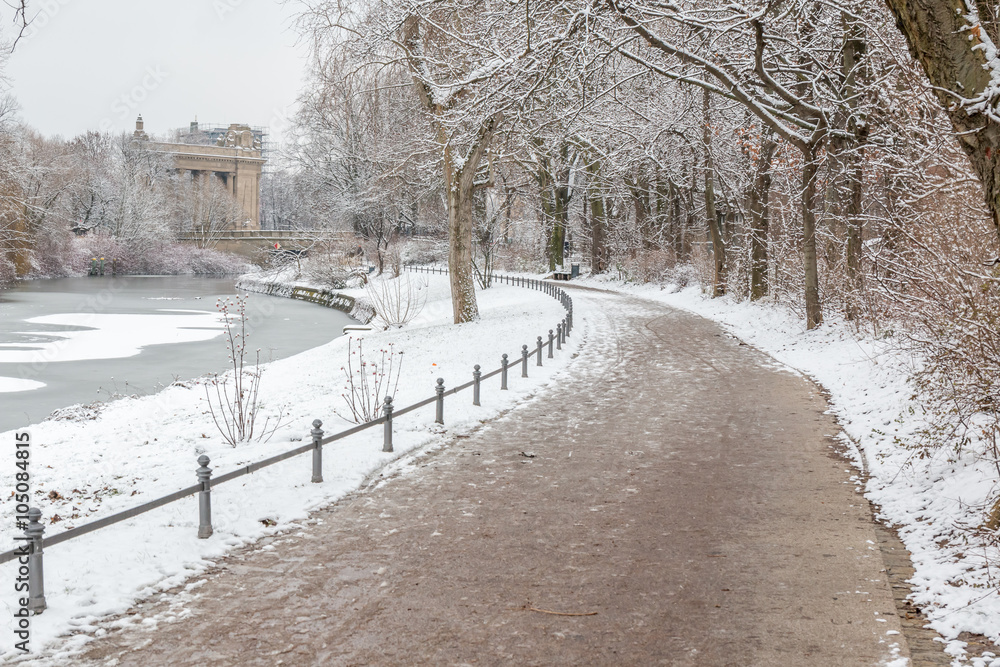 Trail in the park by the river in the snow