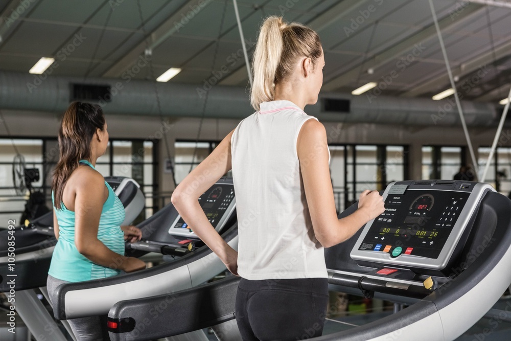 Women exercising on a treadmill Women exercising on a treadmill