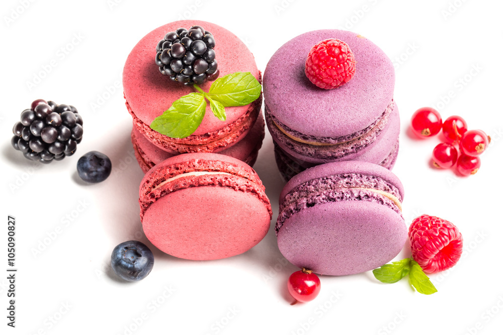 Tasty macaroons with berry fruits on white background