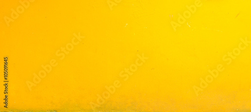 Yellow grunge cement wall for texture background