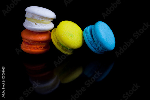 Colorful french macaroons on a black background.