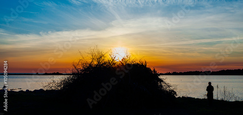 Valborgsmässoafton; en siluett av en otänd brasa i solnedgången photo