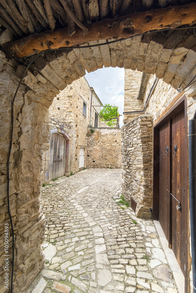 Fisheye view on vanishing medieval narrow pavement street passage with stonemasonry building. Pano Lefkara, Cyprus.
