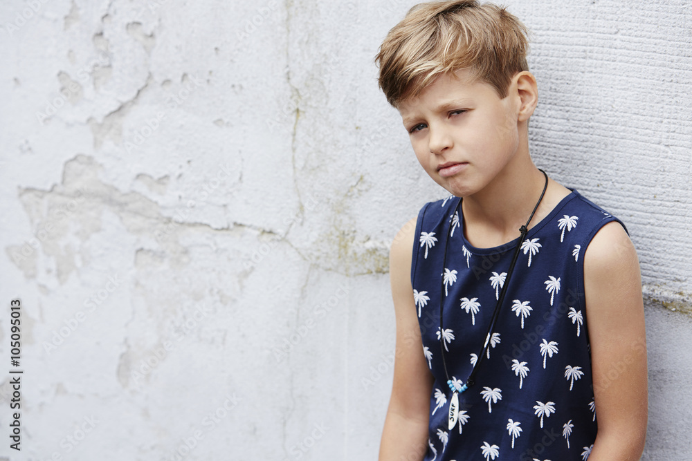 Young boy in vest looking at camera Young boy in vest looking at camera