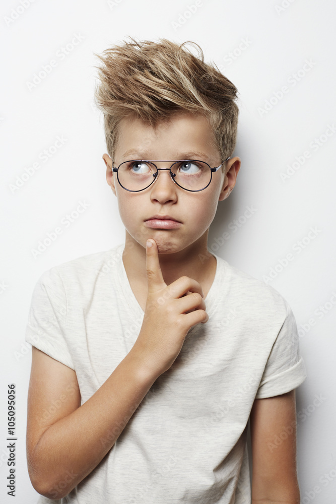 Thoughtful young boy looking up, studio Thoughtful young boy looking up, studio