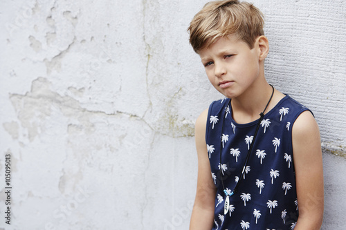 Young boy in vest looking at camera