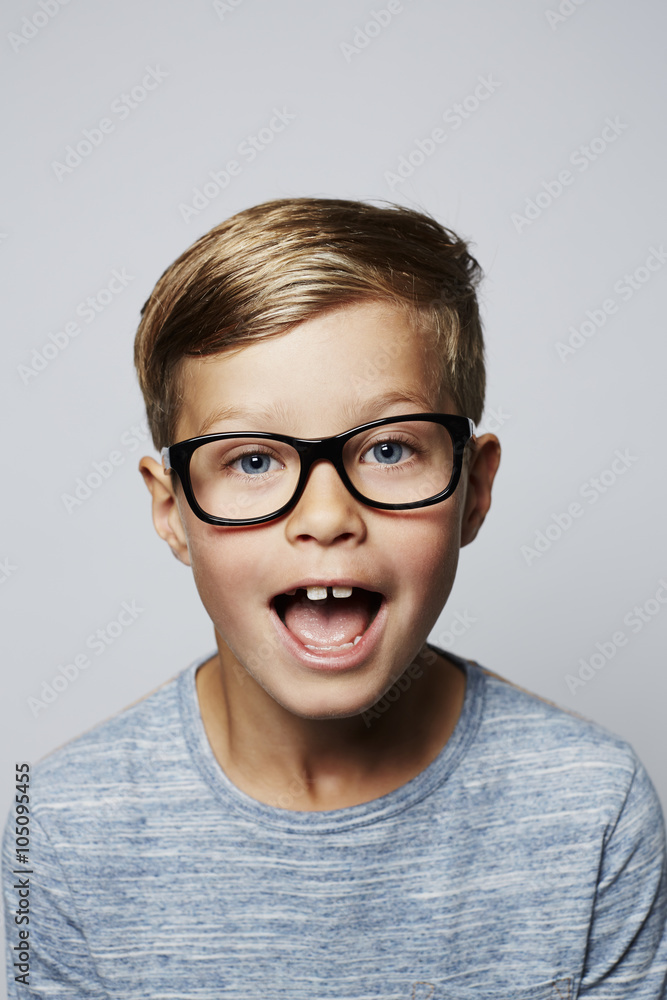 Boy in spectacles looking surprised, portrait