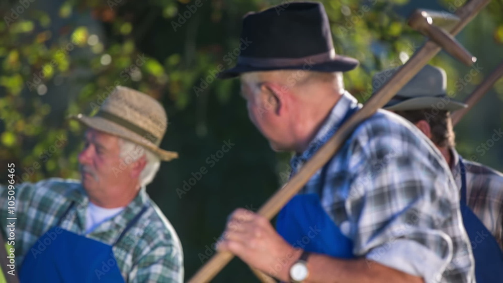 Farmers with a scythes comes on the filed to mow the grass Farmers with a scythes comes on the filed to mow the grass