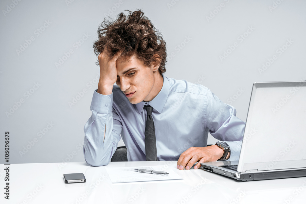 Entrepreneur dissatisfied with his earnings, profit, income, gain, benefit, margin. Modern businessman at the workplace working with computer, depression and crisis concept Entrepreneur dissatisfied with his earnings, profit, income, gain, benefit, margin. Modern businessman at the workplace working with computer, depression and crisis concept