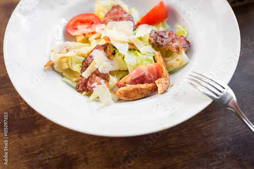 Caesar salad with chicken and tomato