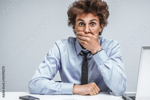 Businessman shocked what happened, looking at camera / modern office man at working place, depression and crisis concept