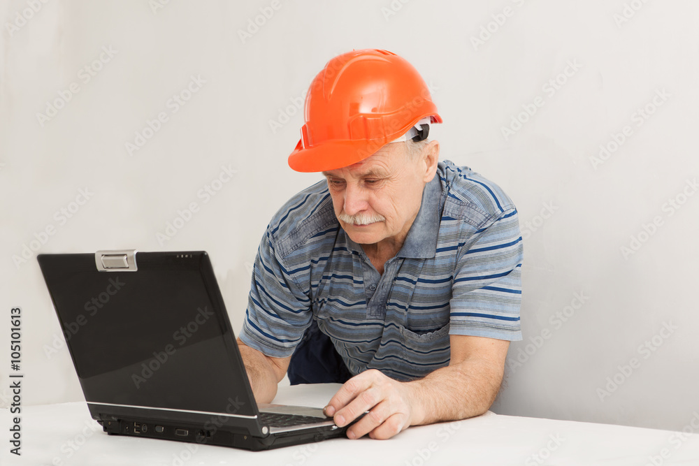 Portrait of construction builder with the laptop