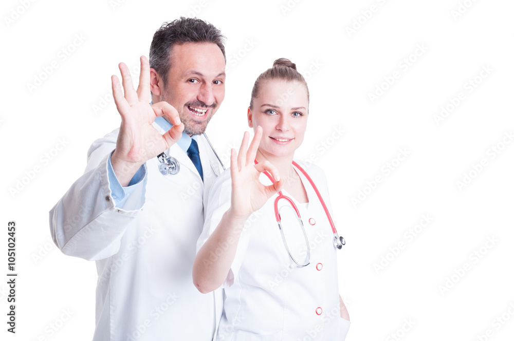 Friendly doctors acting confident and showing ok hand sign Friendly doctors acting confident and showing ok hand sign