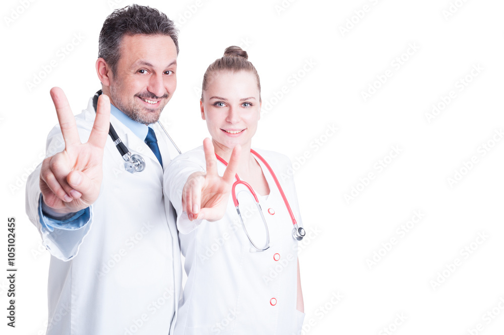 Happy man and female doctors showing victory sign Happy man and female doctors showing victory sign