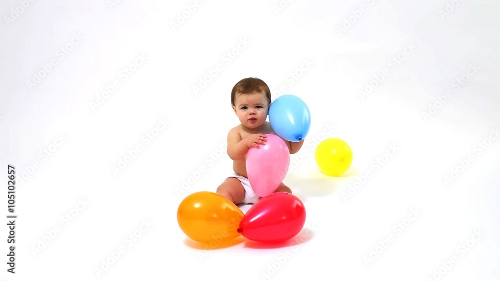 Baby playing with balloons on white background Baby playing with balloons on white background