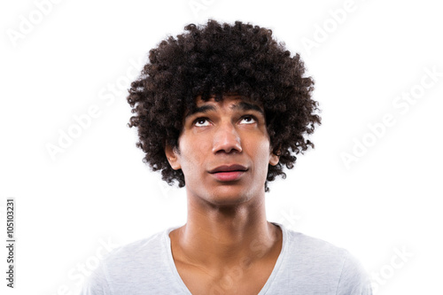 Man with afro hair looking up photo