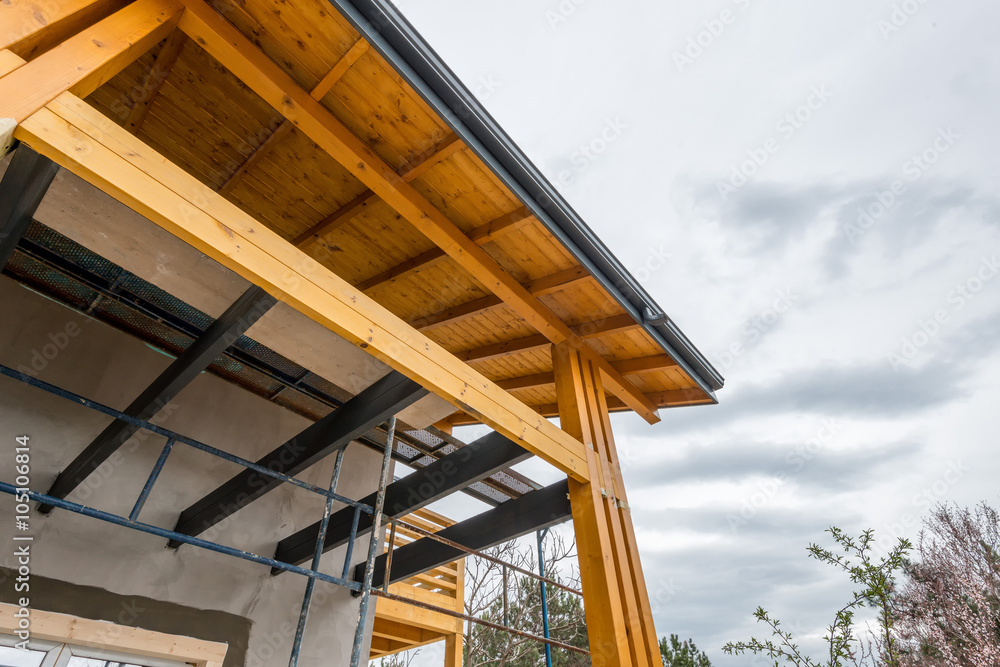 Scaffolding at the construction site of a new wooden house