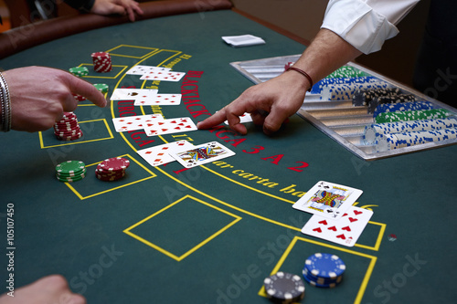 A close up of a blackjack dealer's hands in a casino, very shallow depth of field photo