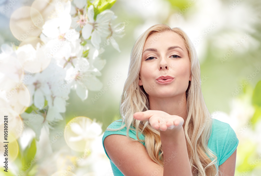 smiling young woman or teen girl sending blow kiss smiling young woman or teen girl sending blow kiss