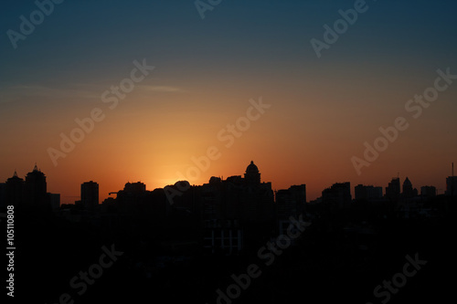 Panoramic silhouette of a big city at sunset. Kiev, Ukraine © DmyTo