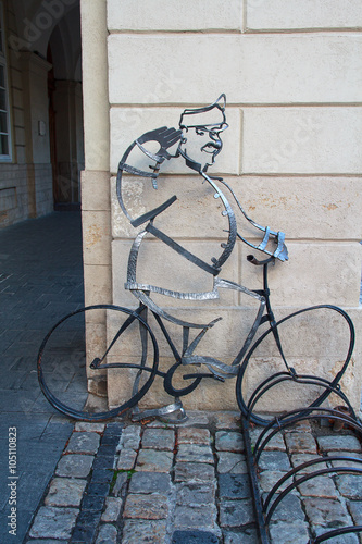 Parking for bicycle with forged metal known literary character - Soldier Schweik. Lviv, Ukraine photo