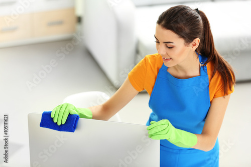 Young woman cleaning comput...