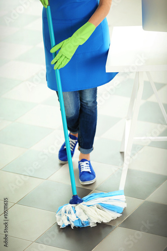Woman cleaning floor with m...