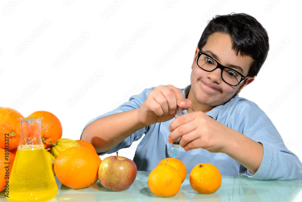 Boy Make the Experiments with Fruit. / Teenage boy performing experiments with fruit.