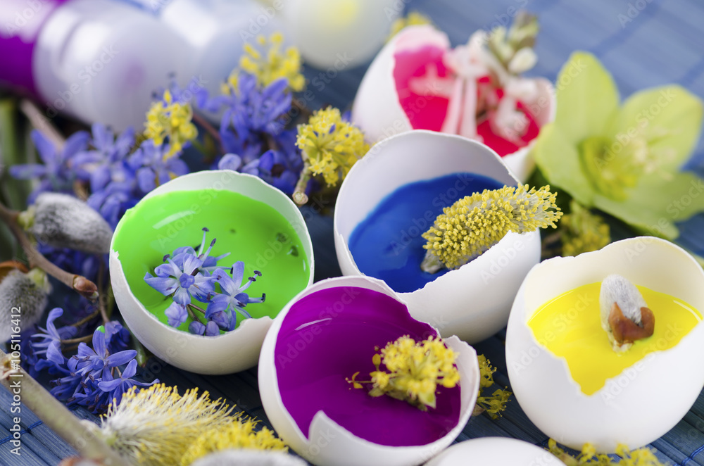 Easter decoration with spring flowers and tempera paint in an egg shell and tubes Easter decoration with spring flowers and tempera paint in an egg shell and tubes