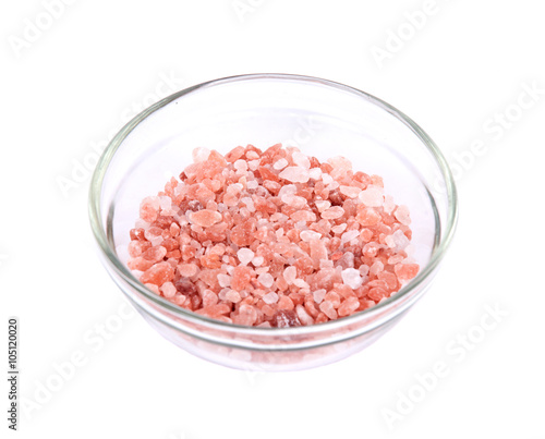 Himalayan pink salt in bowl on white background