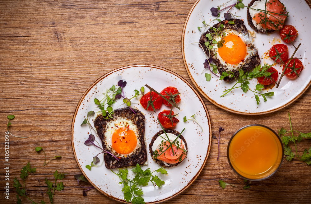 Fried eggs, salmon canape and tomatoes Fried eggs, salmon canape and tomatoes