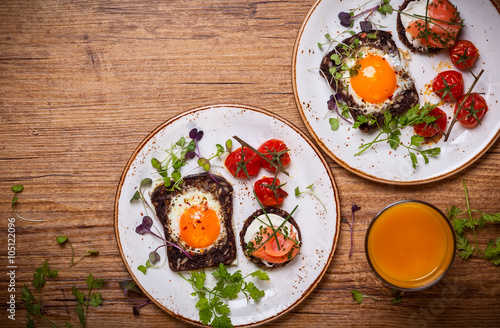 Fried eggs, salmon canape and tomatoes