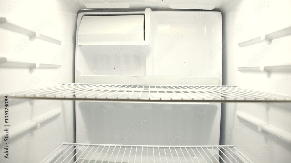 People look for food in empty refrigerator People look for food in empty refrigerator