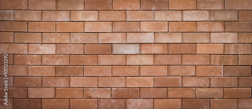 brown grunge brick wall abstract background, blurred and vignette corner